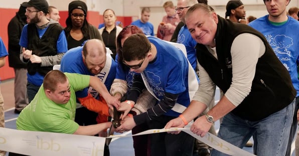 Three gentlemen cutting ribbon for Walk Fundraiser; people in the back getting ready to walk