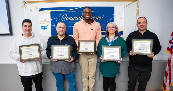 Group of DDI staff holding certificates