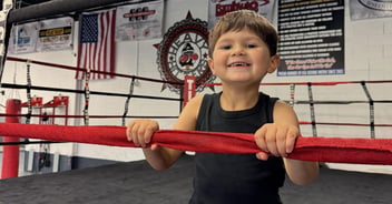 Little boy in a boxing ring