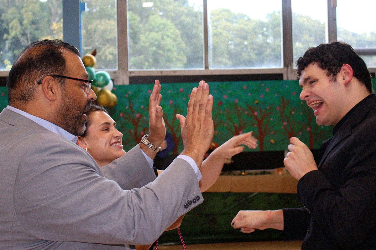 boy giving high five to adult