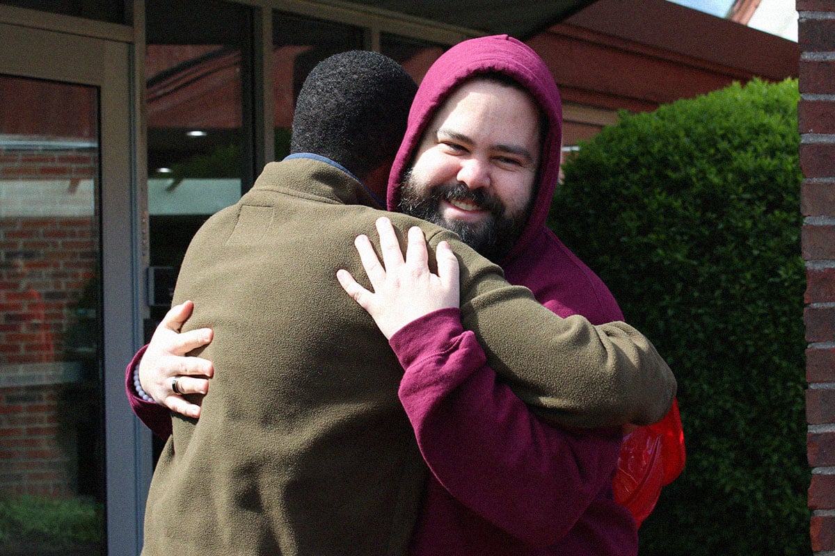 two people hugging outside