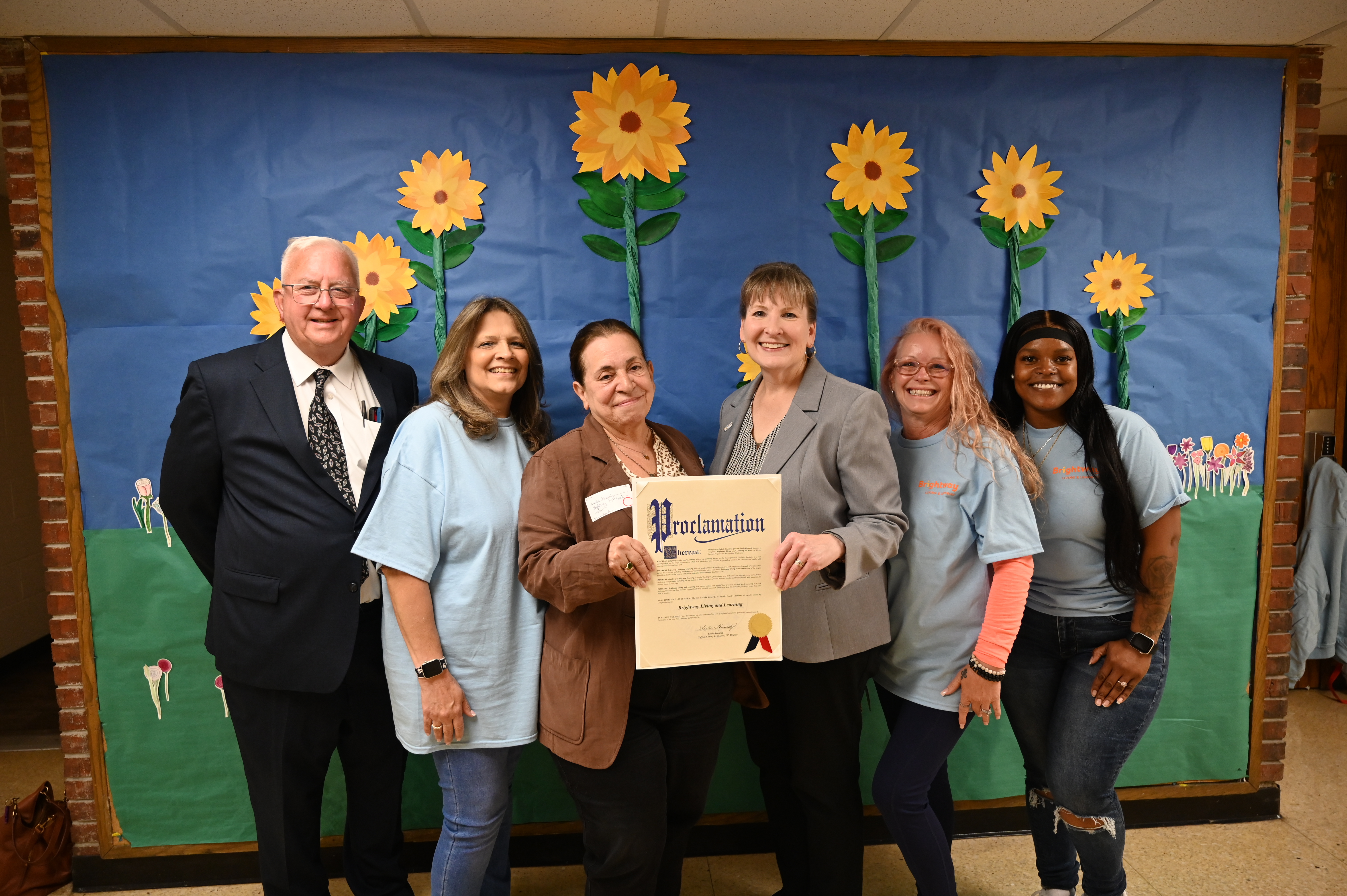 Legislator Leslie Kennedy, Comptroller John Kennedy, Brightway staff receiving proclamation